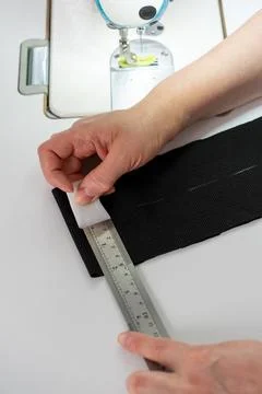 Vertical close up of measuring and marking fabric for tailoring Stock Photos