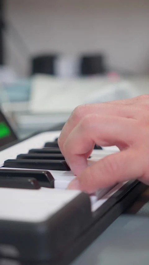 Vertical close up of musician hand performing on white MIDI controller Video stock 338043746