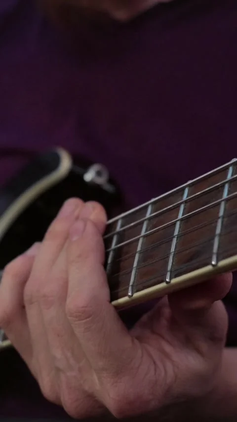 Vertical close up of a musician holding a complex chord on an electric guitar Stock Footage 345211277