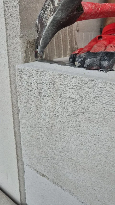 Vertical Close Up Nailing Metal Fixing Strap to Concrete Wall 스톡 동영상 344431742