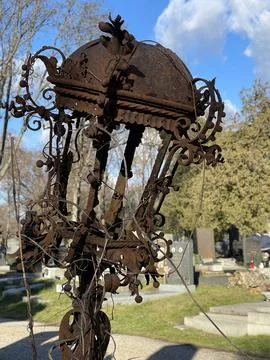 Vertical close up of an old fashioned corroded metal lantern at old cemetery Stock Photos