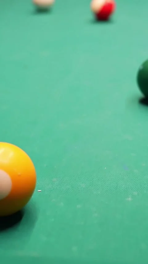 Vertical close-up pan from yellow 1-ball to green 6-ball on teal pool table 스톡 동영상 328651096