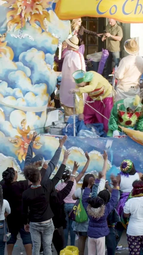 Vertical Close-Up of Paradegoer Reaching for Mardi Gras Beads During Festive Stock Footage 320993579