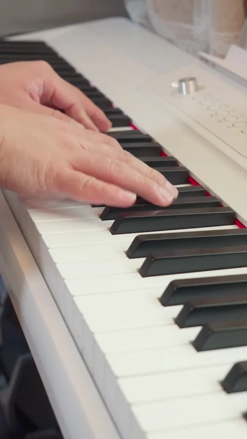 Vertical close up of pianist hands performing classical music on white synthesiz Video stock 337929789
