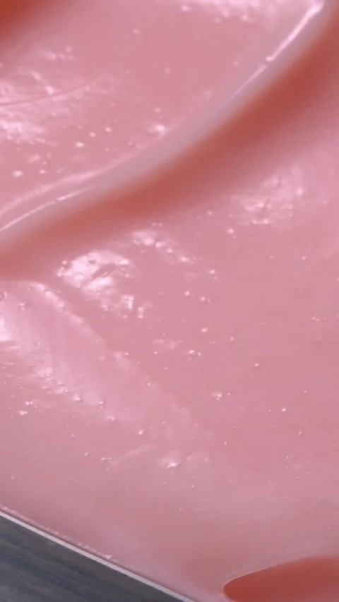 Vertical close-up pink smooth skin cream texture, beauty facial cosmetics mask Stock Footage 278963046