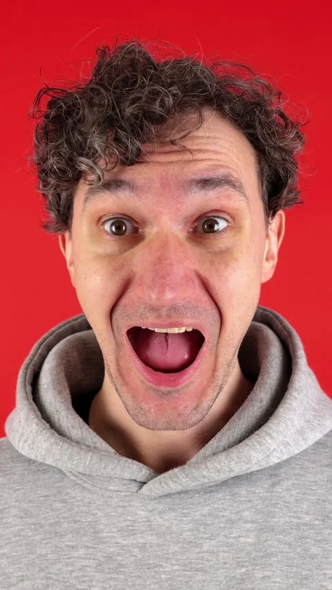 Vertical close up portrait man, joyfully surprised, pronouncing word wow 動画素材 304761927