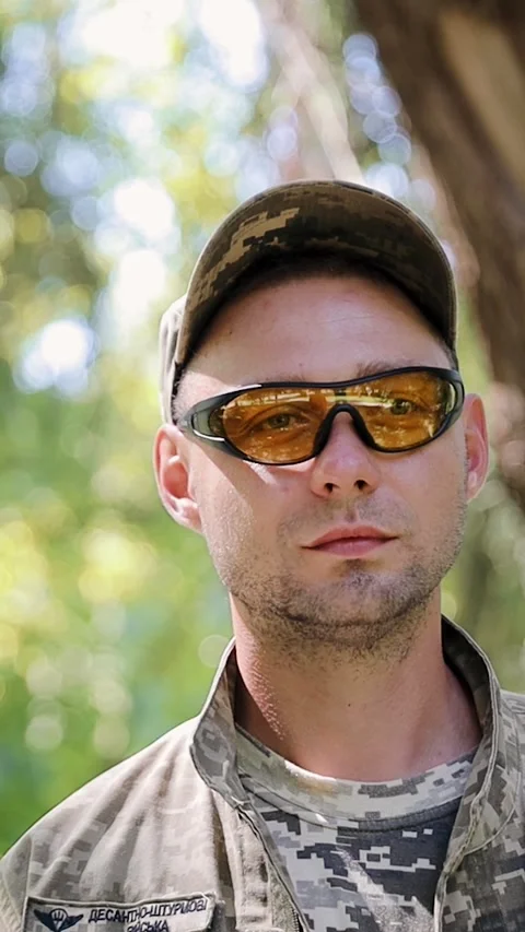 Vertical close-up portrait of a professional young Ukrainian soldier Stock Footage 277134242