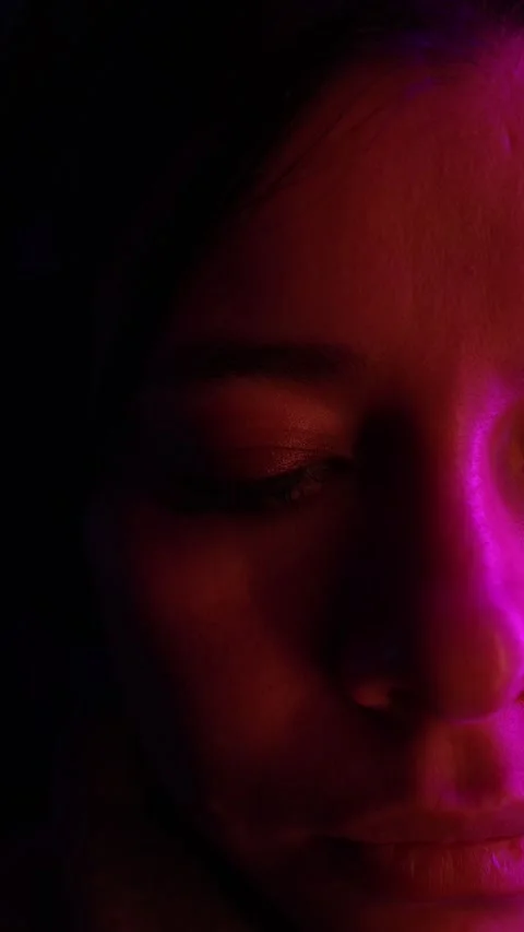 Vertical Close-Up Portrait of Woman in Dramatic Neon Light – Emotional Mood Shot Stock Footage 338167995