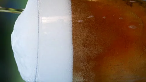 Vertical close-up of pouring beer with foam and bubbles in glass in slow motion Stock-Footage 280161750