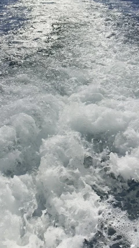 Vertical close up propeller wash white foam churning sea water Stock Footage 345962282