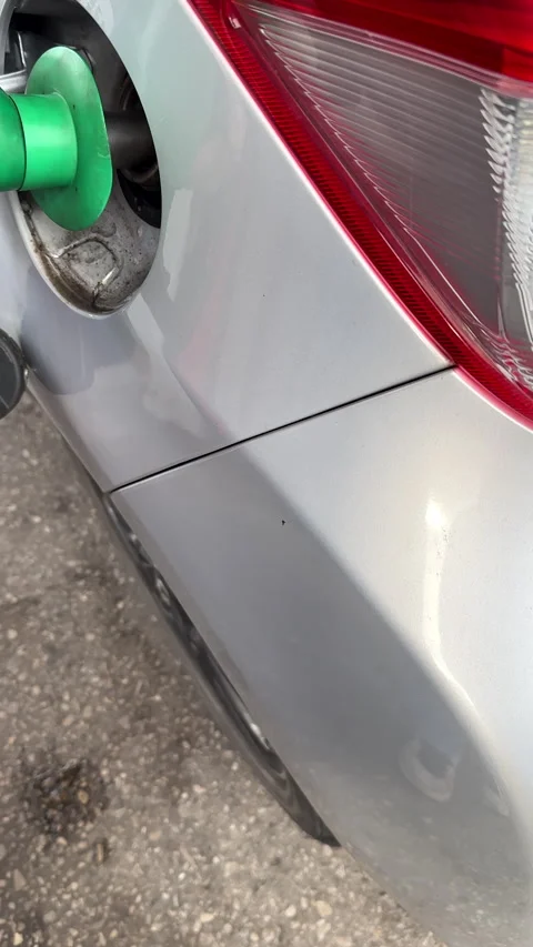 Vertical. Close up of pump nozzle, filling up car fuel tank unleaded petrol gas Stock-Footage 335692526