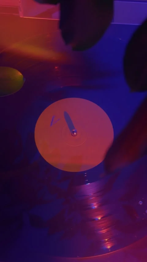 Vertical close push-in vinyl record spinning with emotional warm light Video stock 337242635