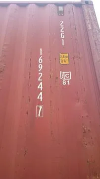 Vertical Close Up of Red Shipping Container with Identification Codes and Ma 库存照片