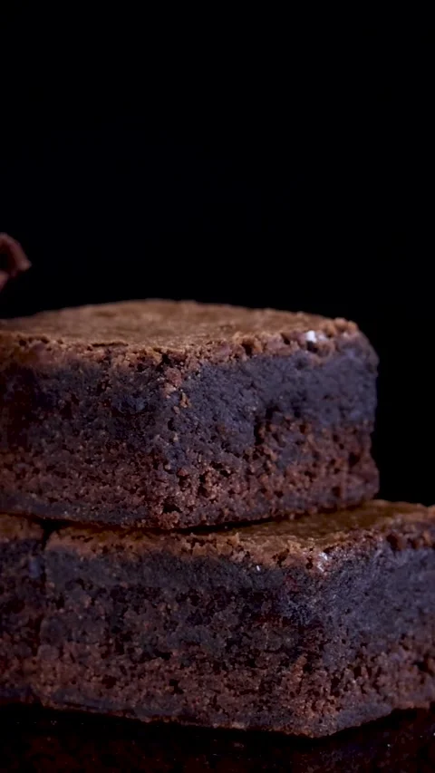 Vertical Close Up of Rotating Stacked Chocolate Brownie Squares Stock Footage 329144171