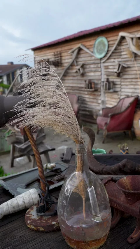 Vertical close up of rustic decorative items and dry plants in an outdoor studio Stock Footage 325205734