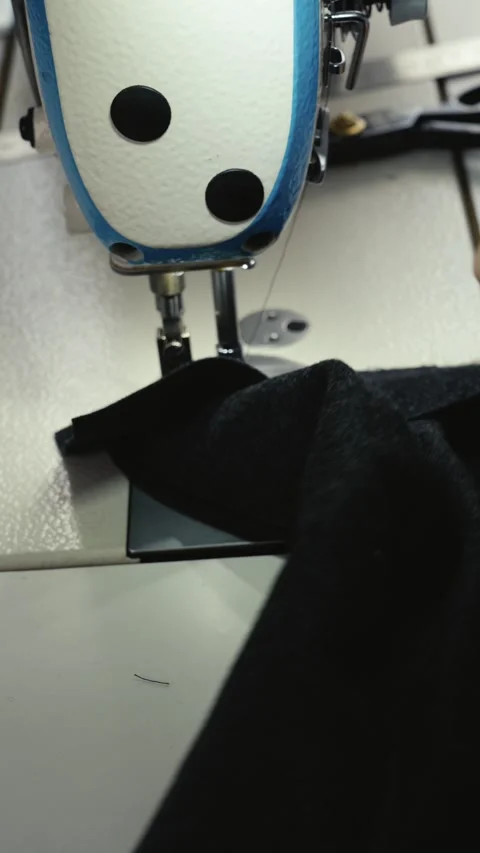 Vertical close up of sewing machine needle stitching fabric Stock Footage 335142992