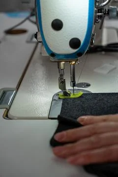 Vertical close up of sewing process with fabric and sewing machine Stock Photos