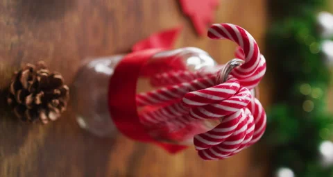 Vertical close-up shot of candy canes in a jar surrounded by Christmas Stock Footage 164535706