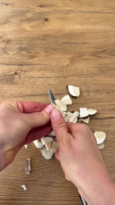Vertical close up shot of finishing slicing wild mushroom with knife on table Stock Footage 346550161