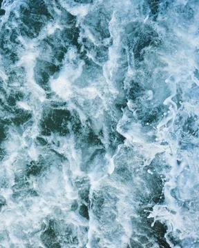 Vertical close-up shot of foamy waves of the sea.Great for a pattern. Stock Photos