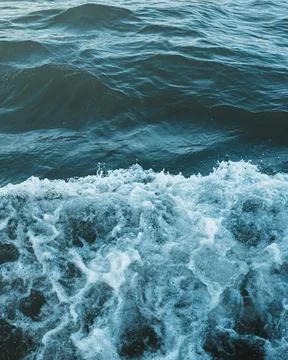 Vertical close-up shot of foamy waves of the sea.Great for a pattern. Stock Photos