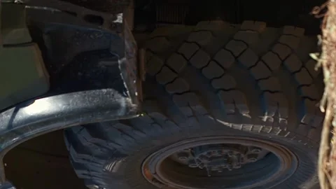 Vertical close-up shot of large timber truck kicks up dust from the road Stock Footage 246959169