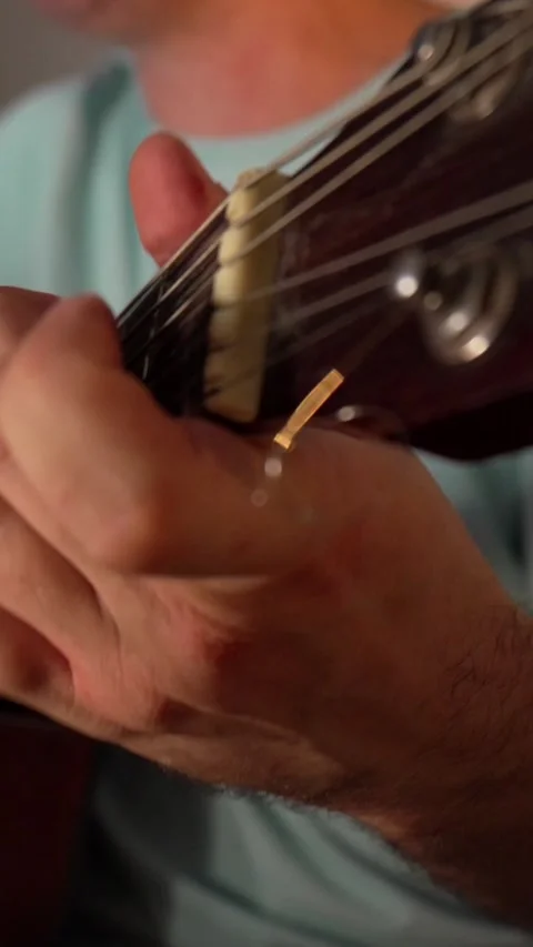 Vertical close up shot of a musician's fingers placing chords and fretting notes Stock Footage 345205853