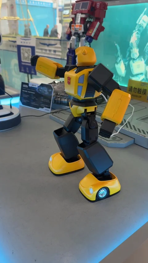 Vertical Close-Up Shot of a Yellow Bumblebee Interactive Robot Displayed at an 動画素材 345648530