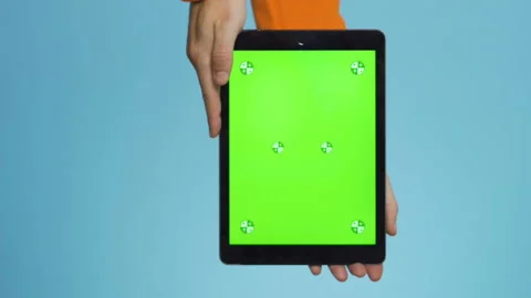 Vertical Close up shoty using a tablet computer with green mockup screen. Stock Footage 231151995