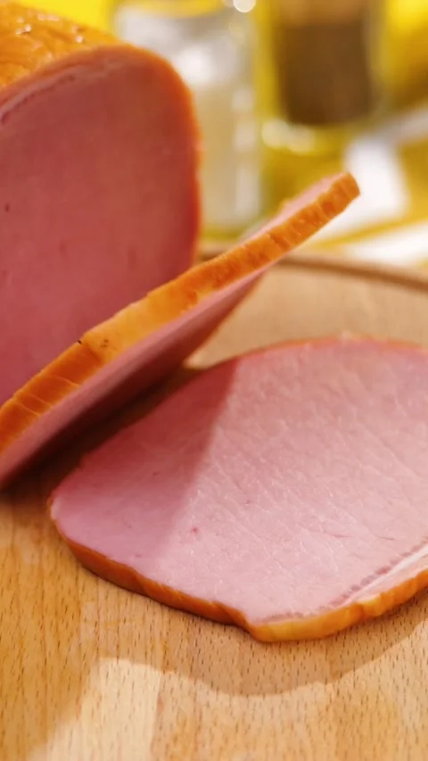Vertical Close-Up Sliced Smoked Ham on Wooden Cutting Board Macro Stock Footage 292562800