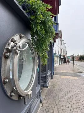 Vertical close up of a submarine porthole window in restaurant exterior Stock Photos