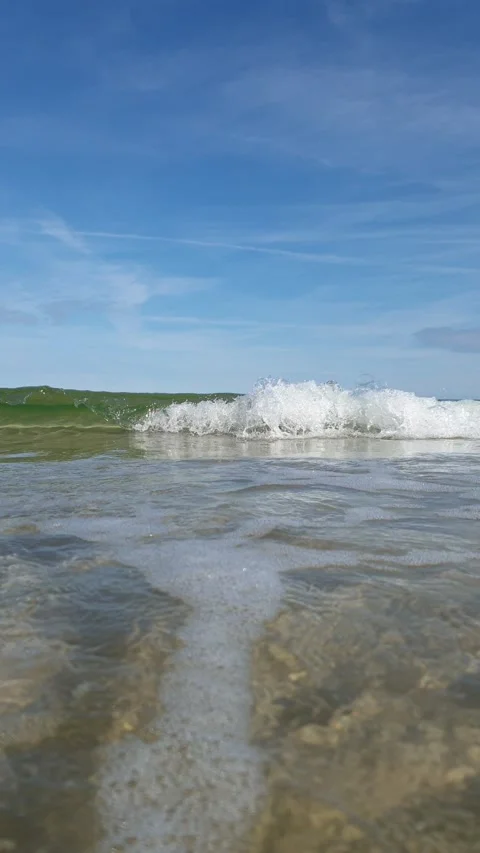 A vertical close-up of the tiny waves right on the camera Stock Footage 171420966