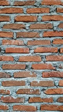Vertical close up of unplastered red brick wall texture background Stock Photos
