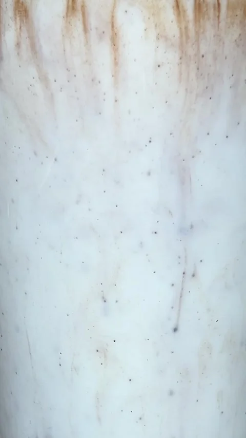 Vertical close up video. 120 fps. Cocoa dissolving in milk Stock Footage 295246127