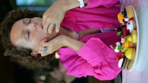 Vertical close-up video of a dreamy romantic woman in a fuchsia shirt. She pops Video stock 216703684