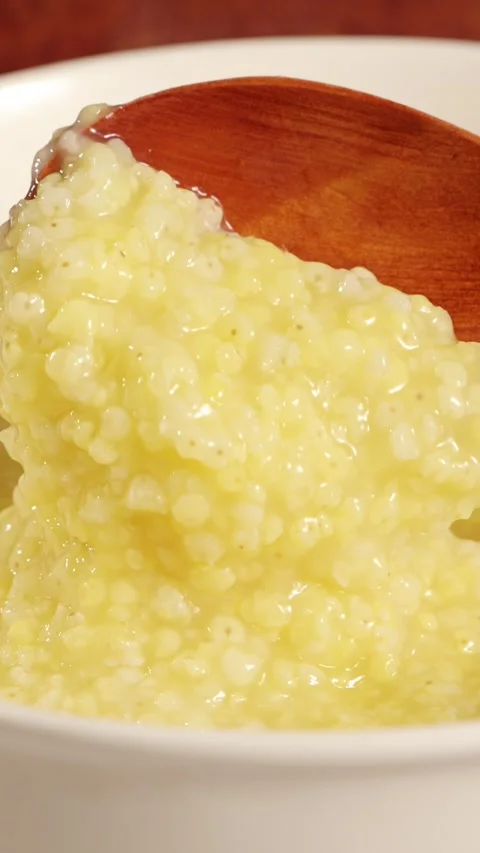 Vertical close‑up video of well‑cooked millet porridge. Stock Footage 343331759
