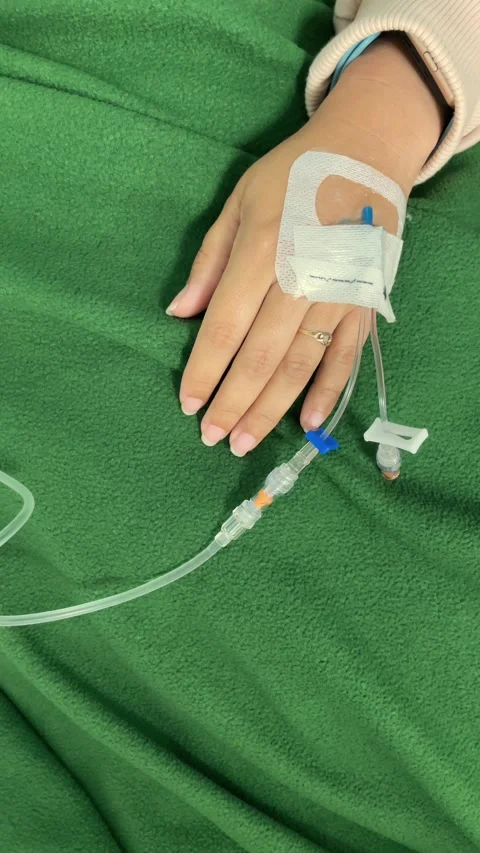 Vertical close-up video of a womans hand with an IV drip inserted, receivin.. Stock Footage 297419068