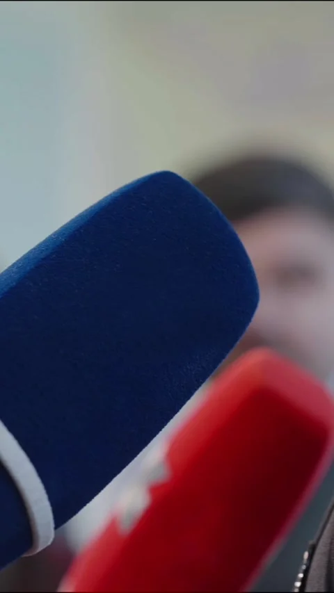Vertical Close up view of blue and red microphones capturing audio during an 스톡 동영상 340563997