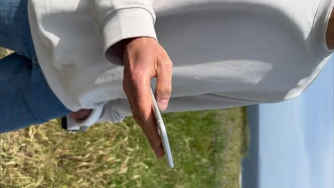 Vertical Close up view of male hands using smartphone scrolling, browsing Stock Footage 241995567