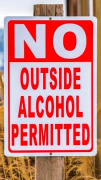 Vertical Close up view of a sign post that reads No Outside Alcohol Permitted Stock Photos