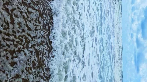 Vertical, Close-up Waves in the Ocean Rolling onto the Shore on a Sunny Summer D Video stock 277653023