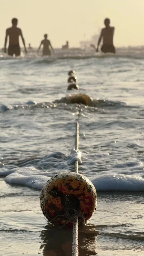 Vertical Close Up of Weathered Beach Buoy on Rope in safety boundary for people Vidéo 342472006