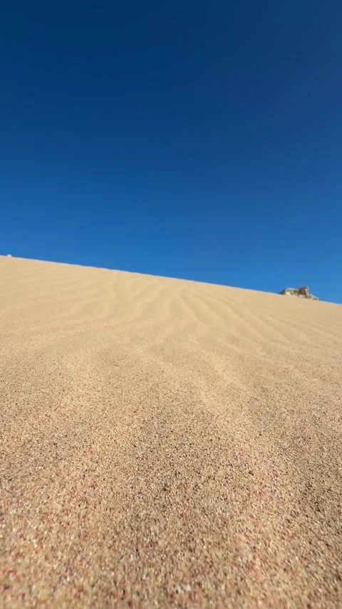 Vertical Close Up of Wind Ripples and Patterns on Golden Sand Dune in the Desert Stock Footage 341995406