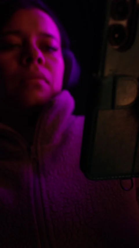 Vertical Close-up of Woman Streaming or Video Calling by Purple Light, Mobile Stock Footage 338168006