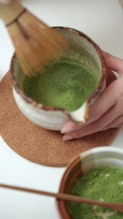 Vertical close up woman's hand making green tea matcha using bamboo natural. Stock Footage 338987973