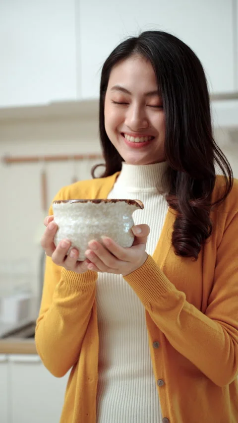 Vertical close up woman's hand making green tea matcha using bamboo natural whis Video stock 338988514