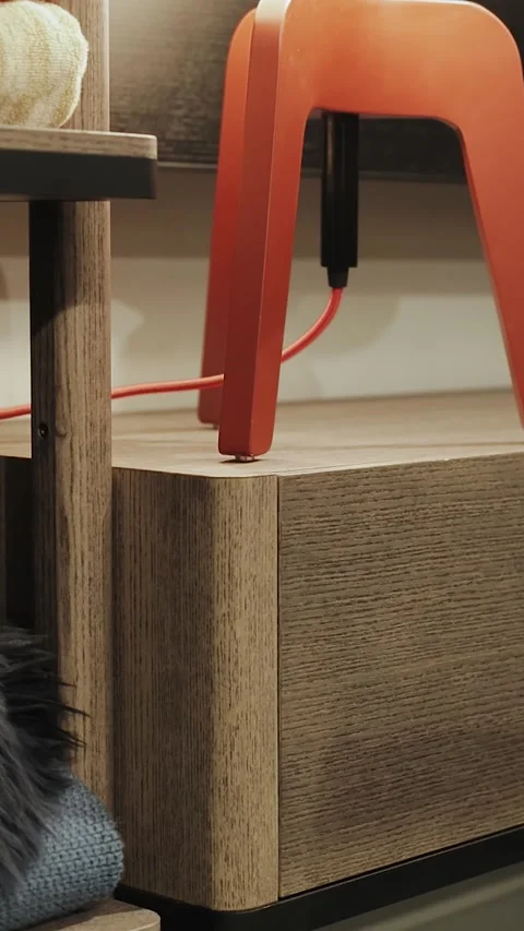Vertical. Close-up of a wooden bedside table with a lamp, the camera moves back Stock Footage 310238236