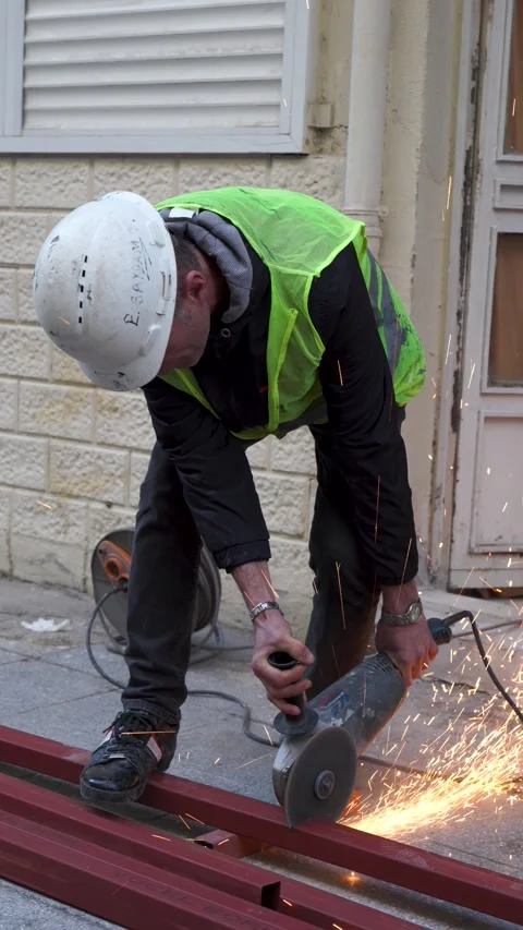 Vertical close-up of worker marking metal beam IZMIR, TURKEY - MARCH 02, 2026: Stock-Footage 330028771