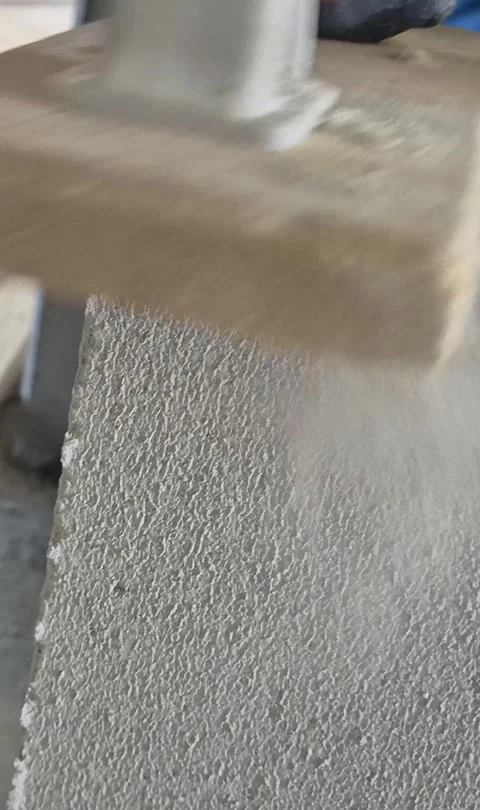 Vertical Close-up of Worker Sanding Aerated Concrete Block Stock Footage 333984253