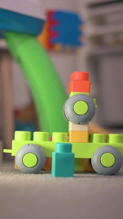 Vertical Closeup Child Hand Placing Round Block On Colorful Toy Construction Stock Footage 330967388